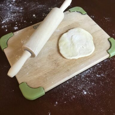 white dough on brown wooden chopping board
