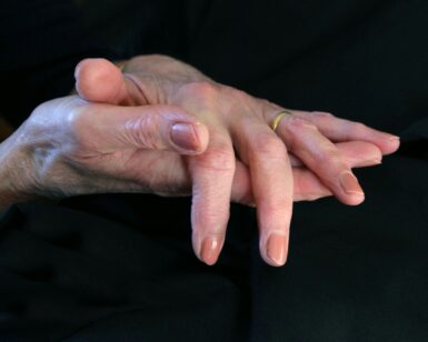 a close up of a person's hands holding another person's hand